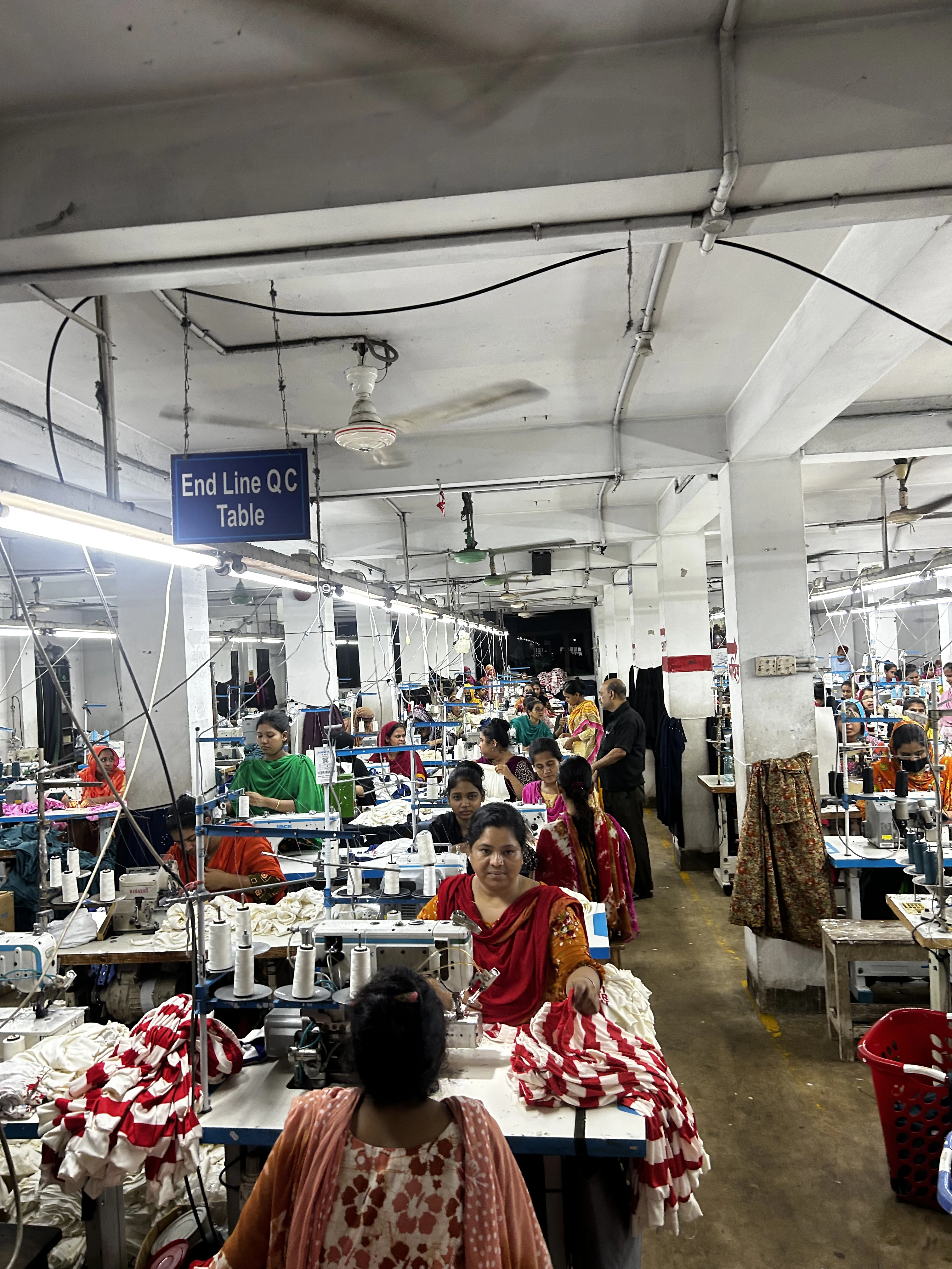 Medical staff performing a clinical breast exam during a factory screening camp
